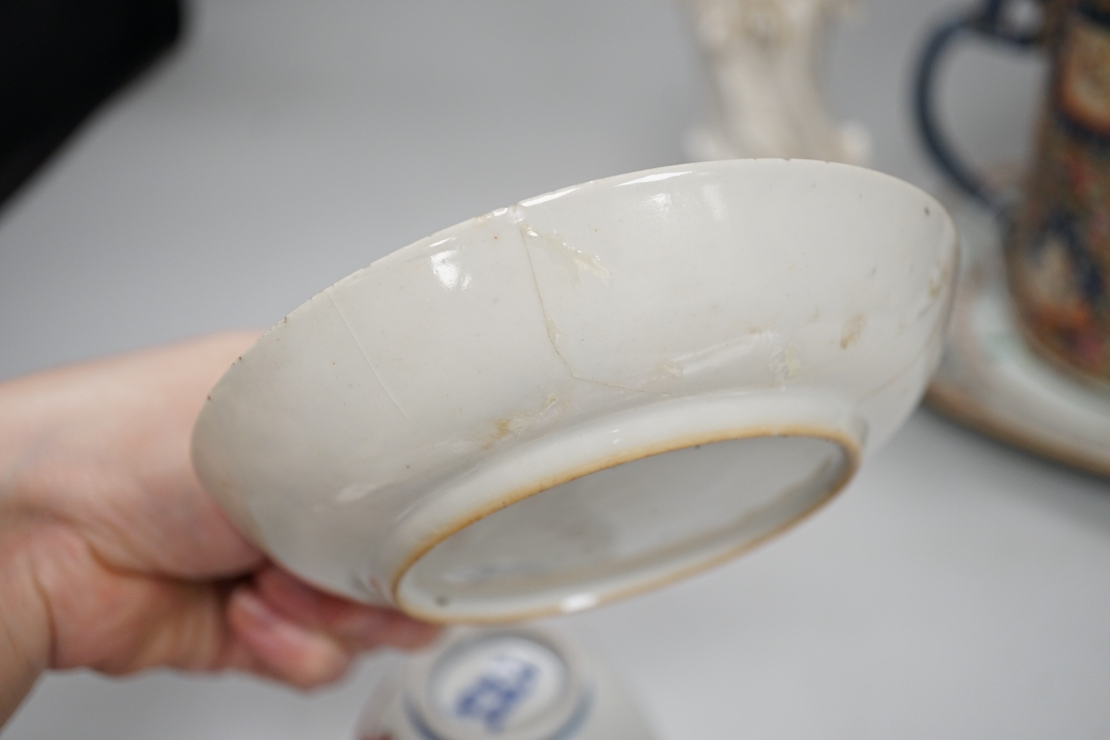 A Chinese figure of blanc de chine, a dragon tea bowl, a saucer, a large tankard, and another Chinese dish, tallest 23cm